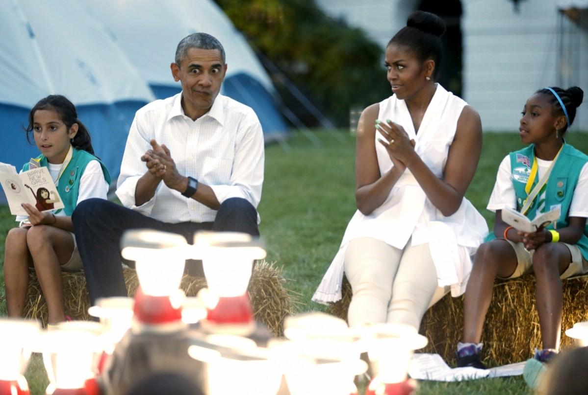 Barack Obama makes a silly face as he and Michelle Obama sing with Girl Scouts during a camp out on the South Lawn of the White House in Washington June 30, 2015. Barack and Michelle Obama
