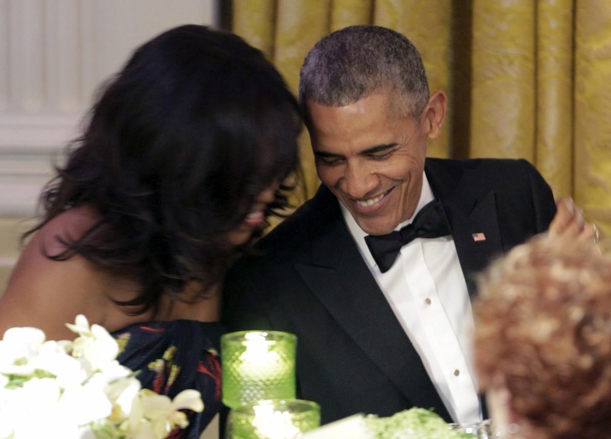 Barack Obama and Michelle Obama hug as the Prime Minister of Canada Justin Trudeau makes a toast during a State Dinner at the White House in Washington March 10, 2016. Barack and Michelle Obama