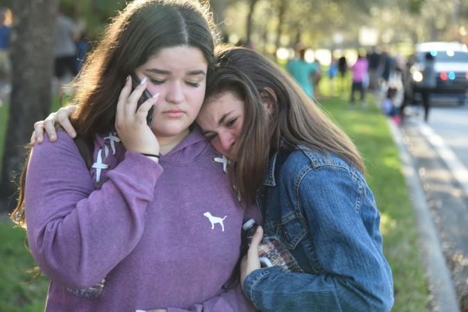 Students react following a shooting at Marjory Stoneman Douglas High School in Parkland, Florida, a city about 50 miles (80 kilometers) north of Miami on February 14, 2018. Florida school shooting