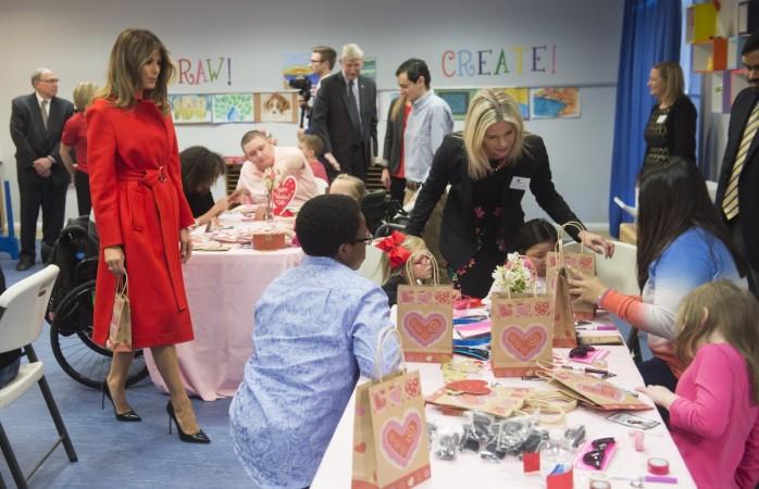 US First Lady Melania Trump exchanges valentines for Valentine's Day with children who are currently patients at the National Institutes of Health (NIH) at The Children's Inn at NIH in Bethesda, Maryland, February 14, 2018. Melania Trump