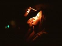 Woman doing her make-up inside a car