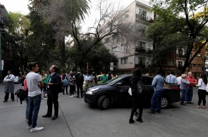 People react on the street after a tremor was felt in Mexico City, Mexico February 16, 2018 Mexico
