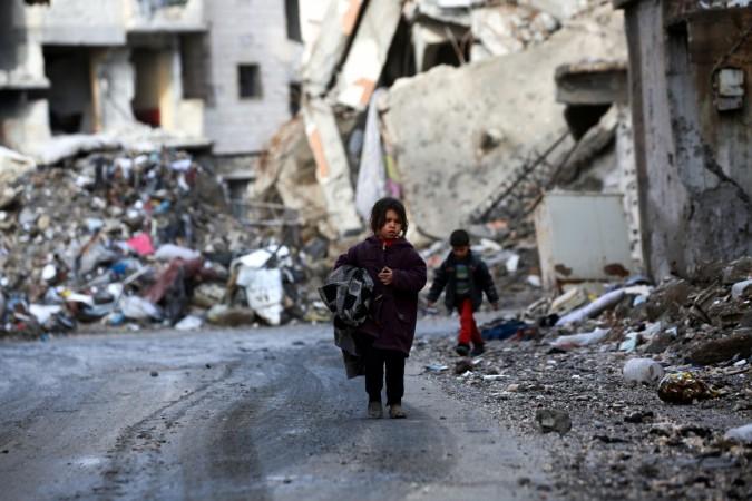 Syrian children walk along a destroyed street in Raqa, the former de facto capital of the Islamic State (IS) group. ISIS children