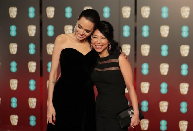 Angelina Jolie poses with Loung Ung on the red carpet upon arrival at the BAFTA British Academy Film Awards at the Royal Albert Hall in London on February 18, 2018. Angelina Jolie Bafta