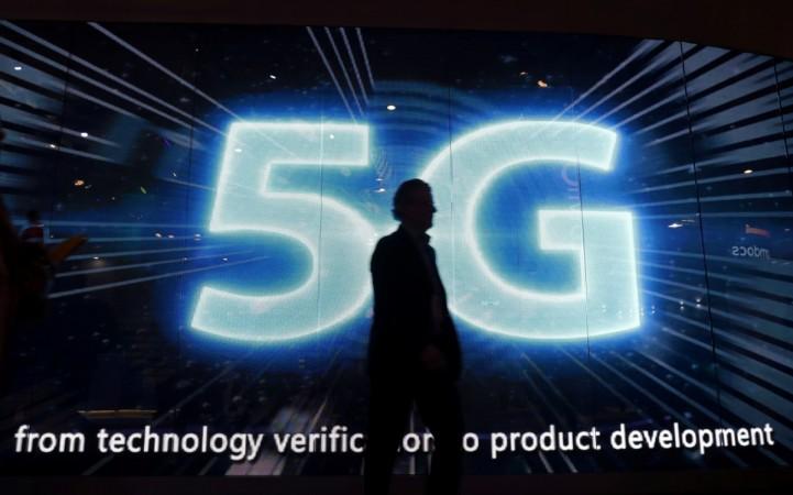 A visitors walks past a 5G sign during Mobile World Congress in Barcelona, Spain