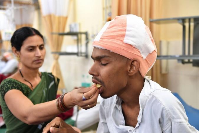 Santlal Pal, 31, rests in his bed as his wife Manju, feeds him a slice of apple at the BYL Nair hospital in Mumbai on February 22, 2018. Indian surgeons who removed a massive brain tumor in a marathon seven-hour procedure said on February 22 it could be the heaviest ever recorded. Santlal had been carrying around a tumor weighing nearly two kilos before the surgery on February 14. Santlal Pal, 31, rests in his bed as his wife Manju, feeds him a slice of apple at the BYL Nair hospital in Mumbai on February 22, 2018. Indian surgeons who removed a massive brain tumour in a marathon seven-hour procedure said on February 22 it could be