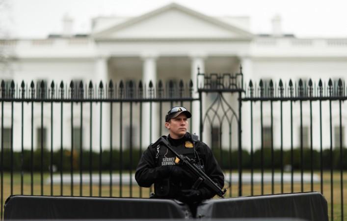 A uniformed Secret Service officer stands guard in front after a passenger vehicle struck a security barrier near the White House in Washington, U.S., February 23, 2018. white house