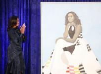 Former U.S. first lady Michelle Obama looks at her newly unveiled portrait during a ceremony at the Smithsonian's National Portrait Gallery