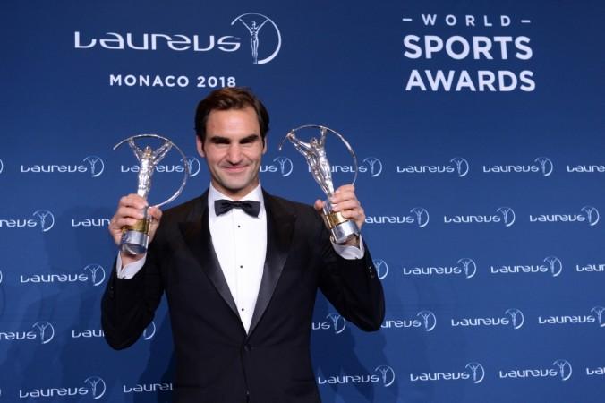 Roger Federer poses with his two Laureus World Sports awards in Monaco Roger Federer poses with his two Laureus Sports awards in Monaco