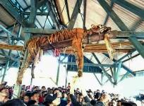 This picture taken on March 4, 2018 shows the carcass of a Sumatran tiger hung from a ceiling as villagers gather underneath at Hatupangan village in North Sumatra. Villagers in a remote Indonesian community disemboweled a critically endangered Sumatran t