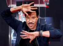 Recording artist Lionel Richie shows his hands after placing them in cement during a ceremony in the forecourt of the TCL Chinese theatre in Los Angeles, California, U.S., March 7, 2018.