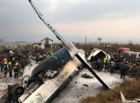 Wreckage of an airplane is pictured as rescue workers operate at Kathmandu airport, Nepal March 12, 2018.