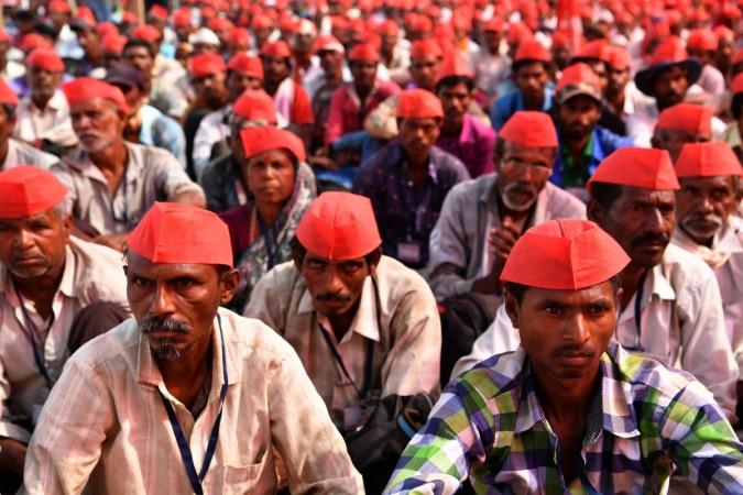 Farmers listen to speakers at the site of a protest rally in Mumbai on March 12, 2018. Maharashtra farmer protests