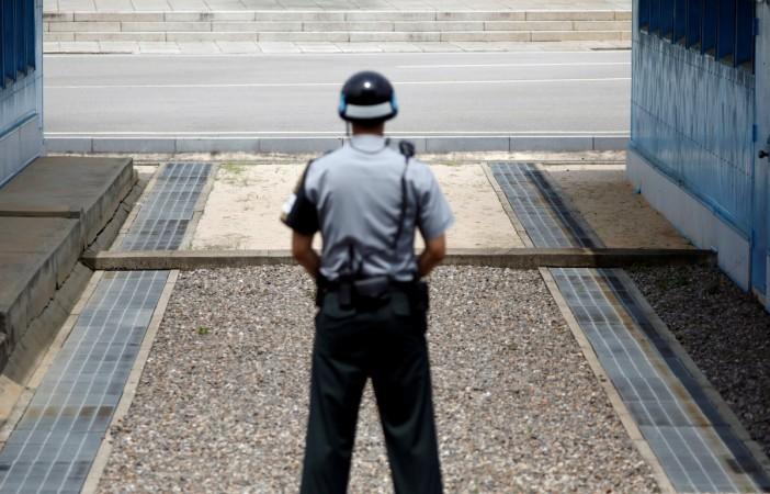 A security official stands guard at the border. north korea border