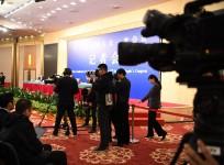 Photographers take pictures during a press conference