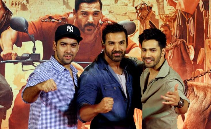 Indian Bollywood actors John Abraham(C) and Varun Dhawan (R) pose as they attend a press conference for the Hindi film Dishoom directed by Rohit Dhawan (L) in Mumbai late August 3, 2016 Dishoom