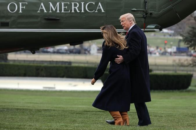 US President Donald Trump walks with First Lady Melania Trump after she tripped on the South Lawn of the White House in Washington, DC, on March 19, 2018. Donald Trump and Melania Trump