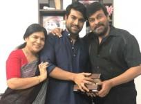 Chiranjeevi and his wife Sureka presenting special gift to son Ram Charan