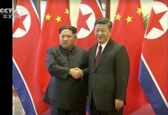 North Korean leader Kim Jong Un shakes hands with Chinese President Xi Jinping, in this still image taken from video released on March 28, 2018. Kim Jong Un and Xi Jinping