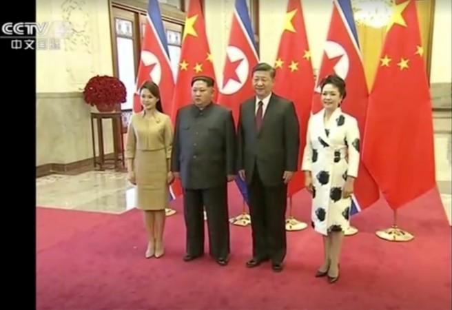 North Korean leader Kim Jong Un and his wife Ri Sol Ju pose for a photo with Chinese President Xi Jinping and his wife Peng Liyuan, in this still image taken from video released on March 28, 2018. Kim Jong Un and Xi Jinping