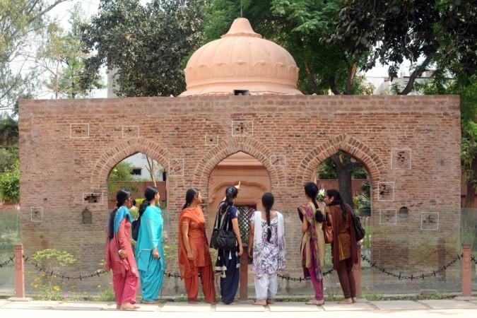Visitors look at the bullet ridden wall at the historical site of the Jallianwala Bagh massacre Jallianwala Bagh massacre