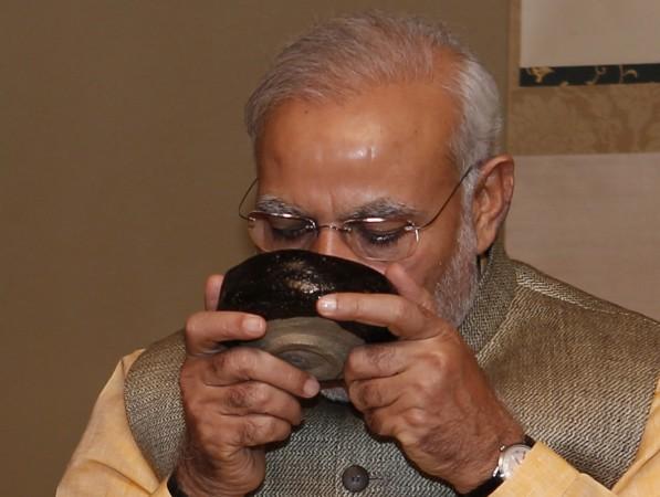 Modi sipping tea during a trip to Japan. modi sipping tea