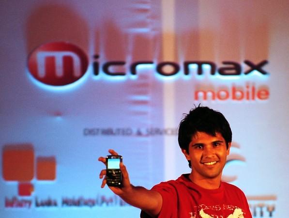 A Sri Lankan model shows an Indian-made mobile phone launched in Colombo during a late night ceremony May 26, 2010. Micromax electric vehicles