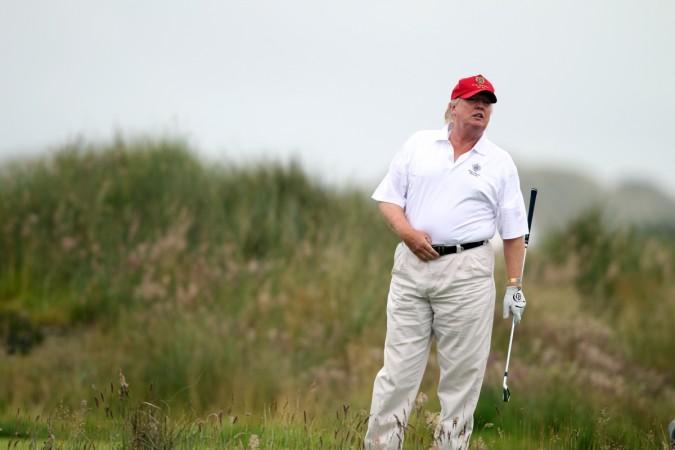 Donald Trump striking a pose while he plays golf. trump playing golf