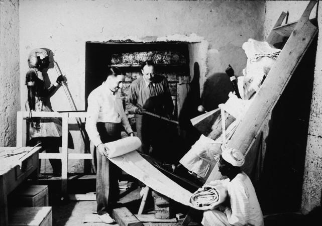 British archaeologists Howard Carter (left) and Arthur Callender carry out the systematic removal of objects from the antechamber of the tomb of Pharaoh Tutankhamen, better known as King Tut, with the assistance of an Egyptian laborer, Valley of the Kings, Thebes, Egypt, 1923 excavation of Tut's tomb