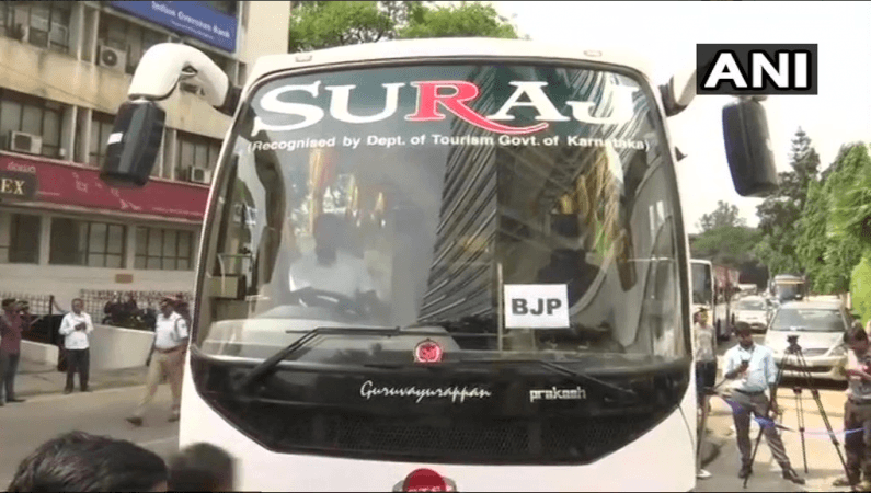 A bus with BJP MLAs arrives at the Shangri-La BJP MLAs