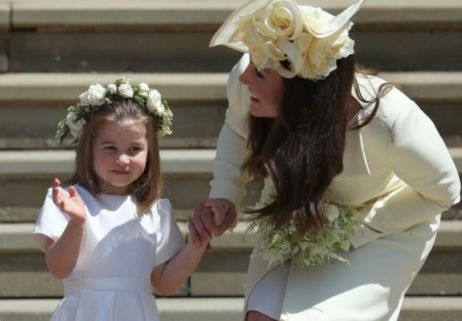 Princess Charlotte (L) waves by her mother Britain's Catherine, Duchess of Cambridge after attending the wedding ceremony of Britain's Prince Harry, Duke of Sussex and US actress Meghan Markle at St George's Chapel, Windsor Castle, in Windsor, on May 19, 2018 Princess Charlotte, Duchess of Cambridge