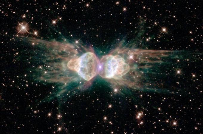 The Ant Nebula, as imaged by the Hubble Space Telescope, resembles the head and body of a garden ant, in reality, it is the result of a dying Sun-like star and complex interactions of material at its heart Ant Nebula