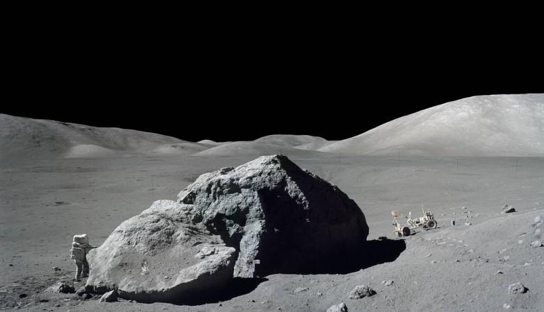 Scientist-astronaut Harrison H. Schmitt is photographed standing next to a huge, split lunar boulder during the third Apollo 17 extravehicular activity (EVA) at the Taurus-Littrow landing site Apollo 17