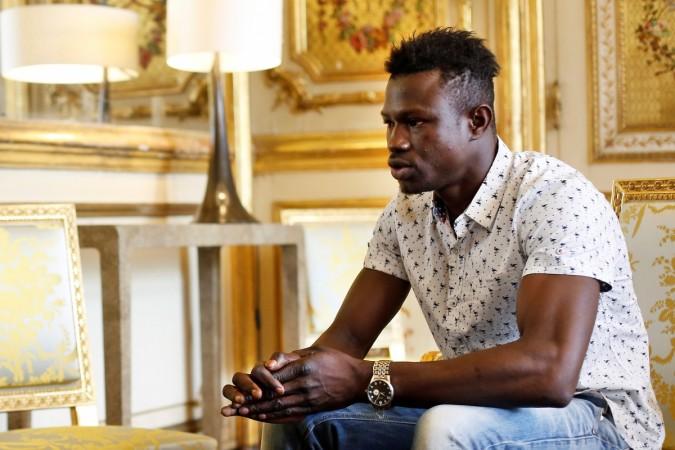 Gassama pictured at the Presidential Palace. Gassama