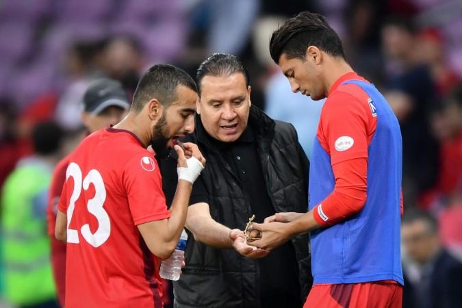 Tunisia's head coach Nabil Maaloul (C) distributes dates to Tunisia's midfielder Naim Sliti (L) and Tunisia's defender Rami Bedoui during the friendly football match between Tunisia and Turkey Tunisia's head coach Nabil Maaloul (C) distributes dates to Tunisia's midfielder Naim Sliti (L) and Tunisia's defender Rami Bedoui