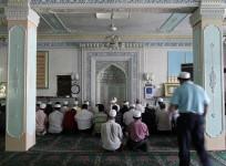 Ethnic Uyghurs pray inside a mosque