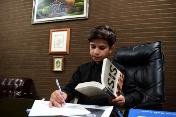 11-year-old Pakistani motivational coach Hammad Safi takes notes at a languages academy in Peshawar. 11-year-old Pakistani motivational coach Hammad Safi