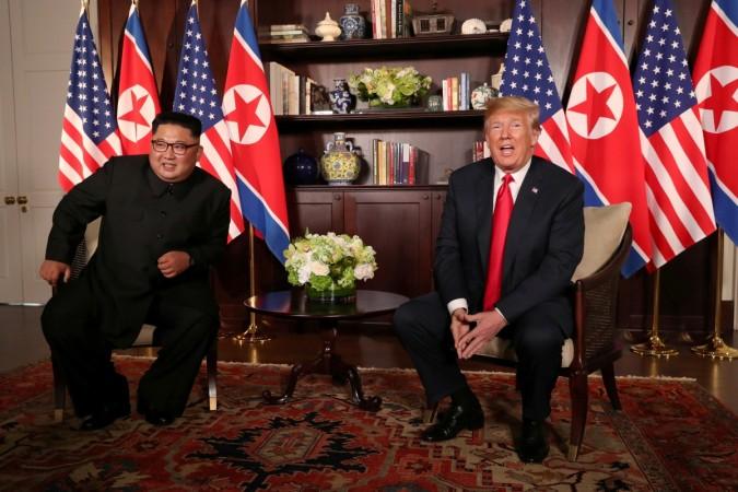 U.S. President Donald Trump sits next to North Korea's leader Kim Jong Un before their bilateral meeting at the Capella Hotel Donald Trump Kim Jong Un