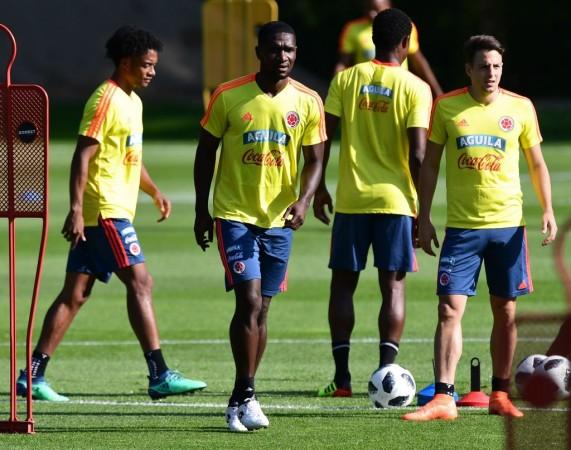 Midfielder Juan Cuadrado, defender Cristian Zapata and defender Santiago Arias stand on the pitch during a training session Colombia Fifa World Cup team