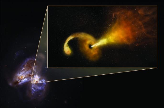 Artist's conception in pullout -- background is Hubble Space Telescope image of Arp 299, a pair of colliding galaxies Black hole eats star