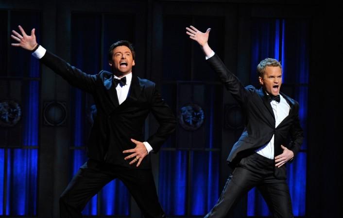 Hugh Jackman (L) and Neil Patrick Harris speak on stage during the 65th Annual Tony Awards at the Beacon Theatre on June 12, 2011 Neil Patrick Harris, Hugh Jackman