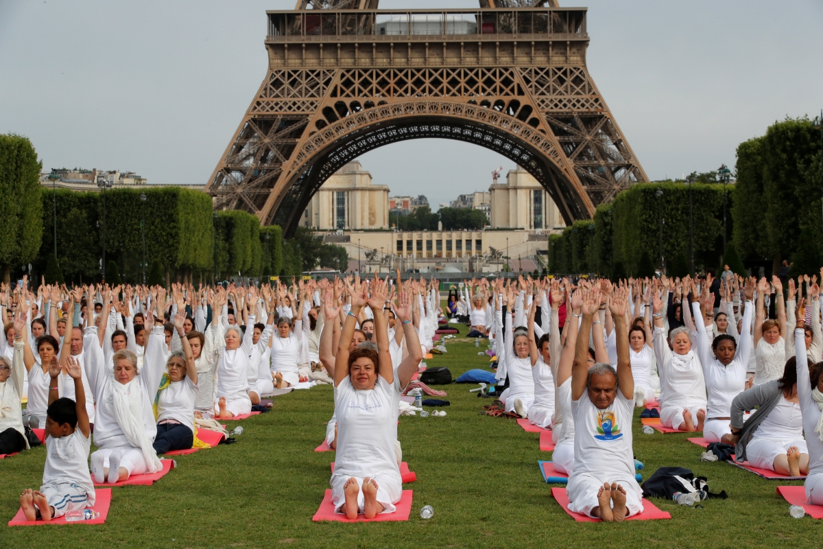People gather for an open-air yoga session near the Eiffel tower in Paris, France June 17, 2018. Yoga