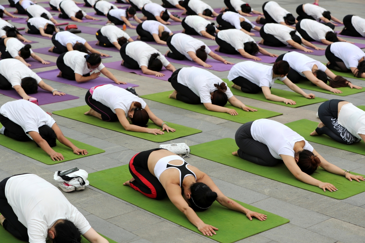 People practice yoga in Xiangyang, Hubei province, China June 17, 2018 yoga