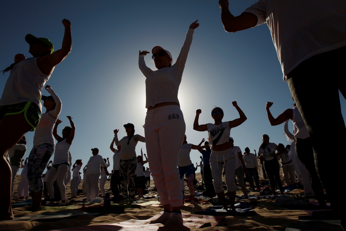 Yoga enthusiasts take part in a class at the Samalayuca dunes, on the outskirts of Ciudad Juarez, Mexico. Yoga