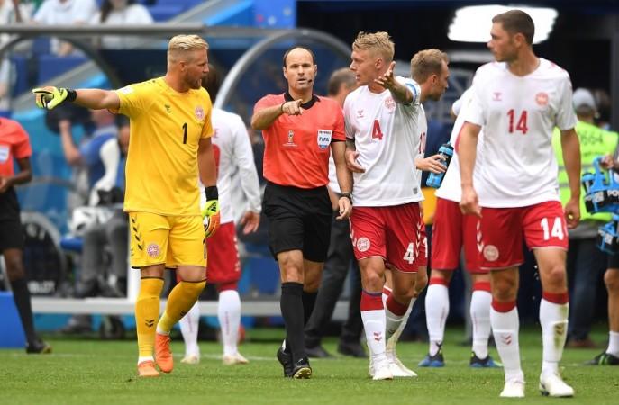 Referee Antonio Mateu Lahoz points to the penalty spot after a VAR review as Denmark players protest VAR Denmark Australia