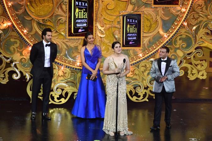 Bollywood actress Meher Vij (2nd-R) receives the award for performance in a supporting role - female for 'Secret Superstar' from Bollywood actor Varun Dhawan (L), actress Radhika Apte (2nd-L) and Yogesh Jain (R) managing director of Whoosh during the IIFA Awards Meher Vij