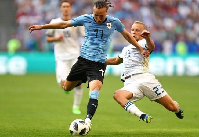 Igor Smolnikov makes the challenge on Diego Laxalt that leads to the second yellow card Laxalt Uruguay Smolnikov Russia