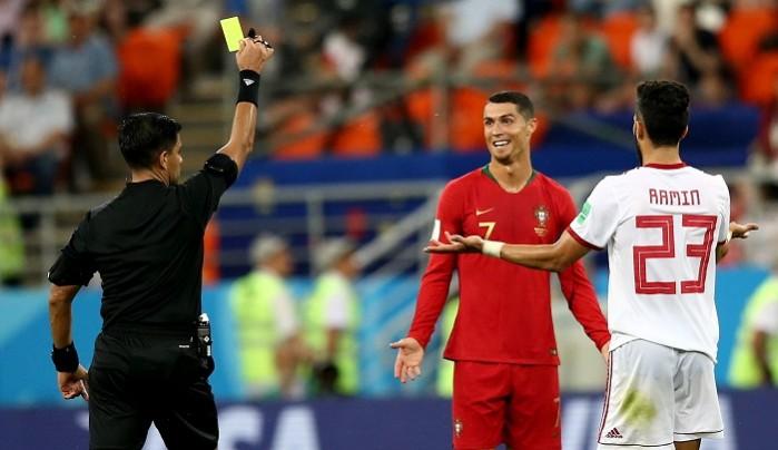Cristiano Ronaldo reacts to being shown a yellow card. It could have been worse, it might have been a red. Cristiano Ronaldo Portugal Iran referee yellow card