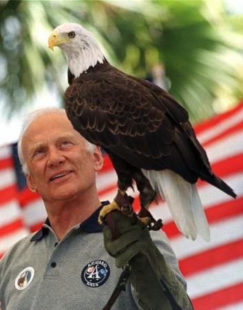 Apollo 11 astronaut Buzz Aldrin holds a bald eagle during a celebration of the mission which took man to the moon for the first time on the 30th anniversary of the flight at the Kennedy Space Center July 17, 1999. Buzz Aldrin and a bald eagle