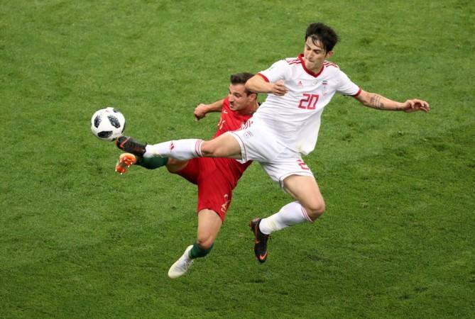 Portugal's Cedric Soares (maroon jersy) in action with Iran's Sardar Azmoun (white jersy) Sardar Azmoun, Iran football team